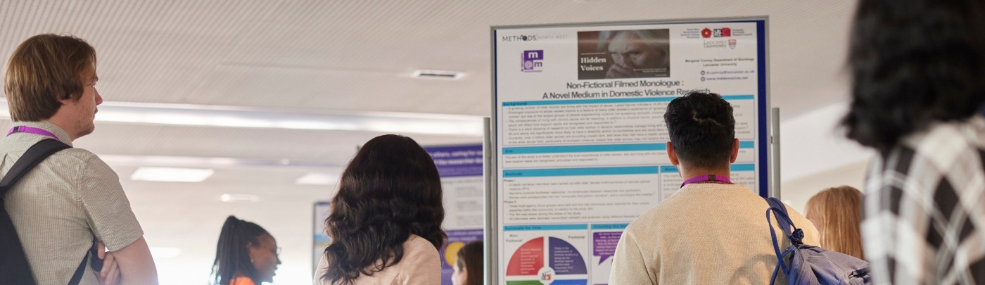 Academic staff members looking at research banners.